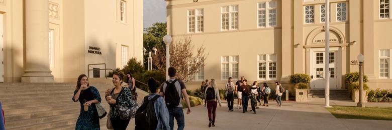 Chapman Student walking in front of Memorial Hall